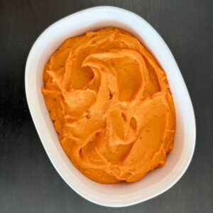 Chipotle sweet potato puree in a white dish.