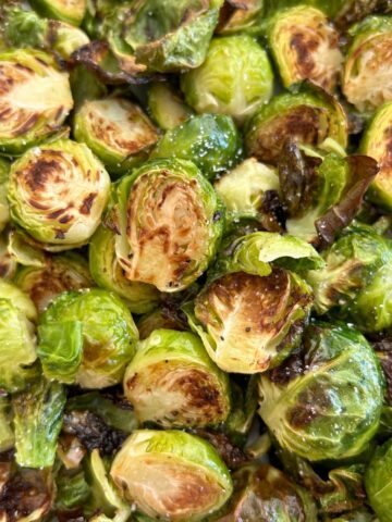 Close up picture of Crispy Oven Roasted Brussels Sprouts in a pile.