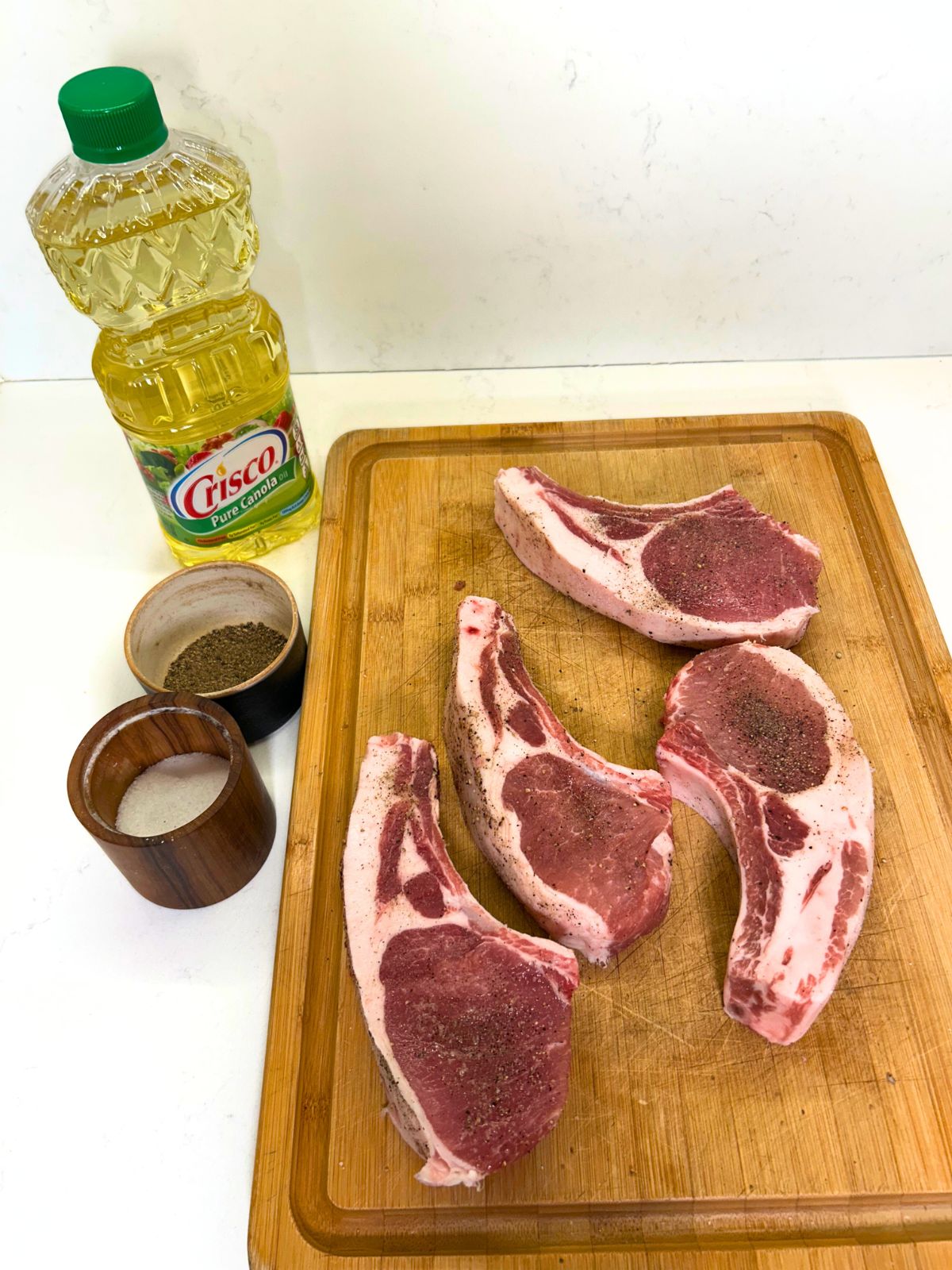 Ingredients needed to pan-sear thick-cut bone-in pork chops.