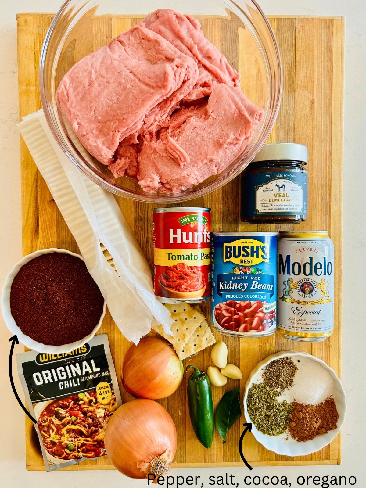 The ingredients needed to make thick homemade chili laying on a cutting board.