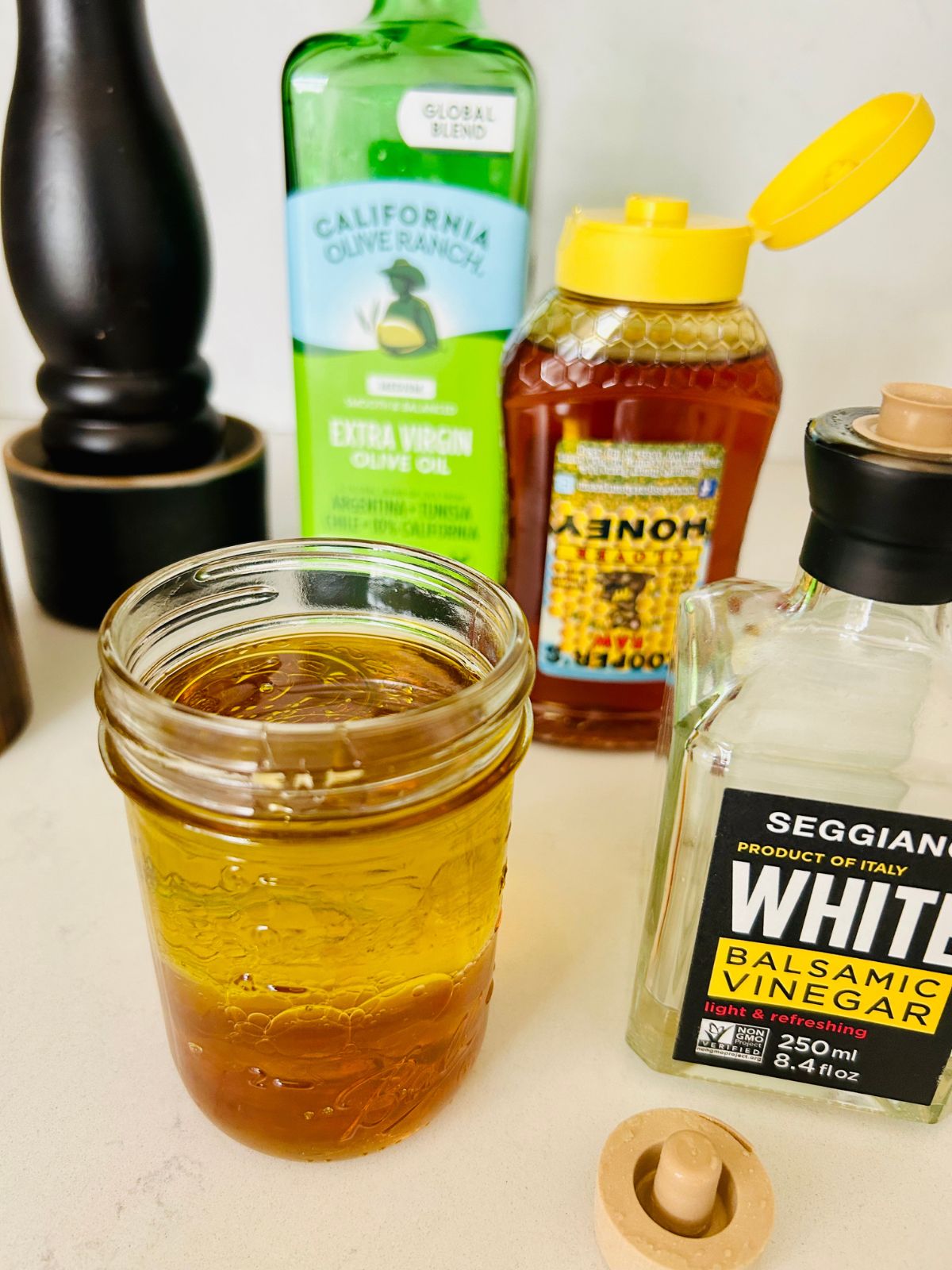 White balsamic vinaigrette ingredients in a mason jar before shaking it.