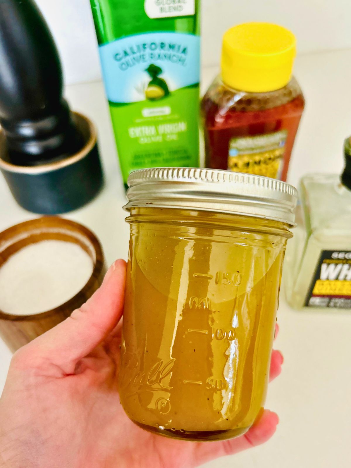 The mason jar of vinaigrette after it has been combined.