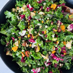 Roasted seasonal vegetable salad like North Italia in a large black bowl.