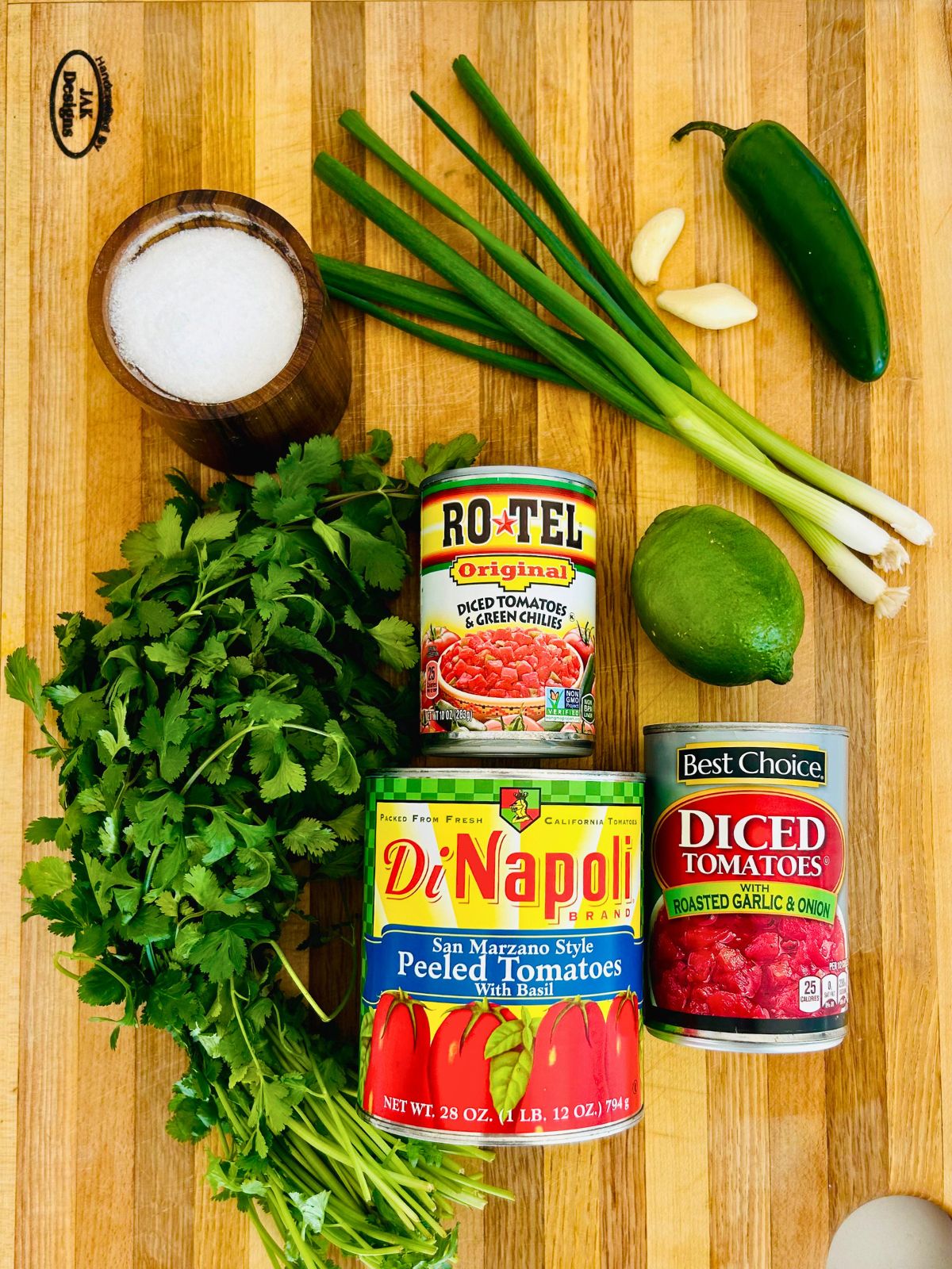 The ingredients needed to make salsa with canned tomatoes.