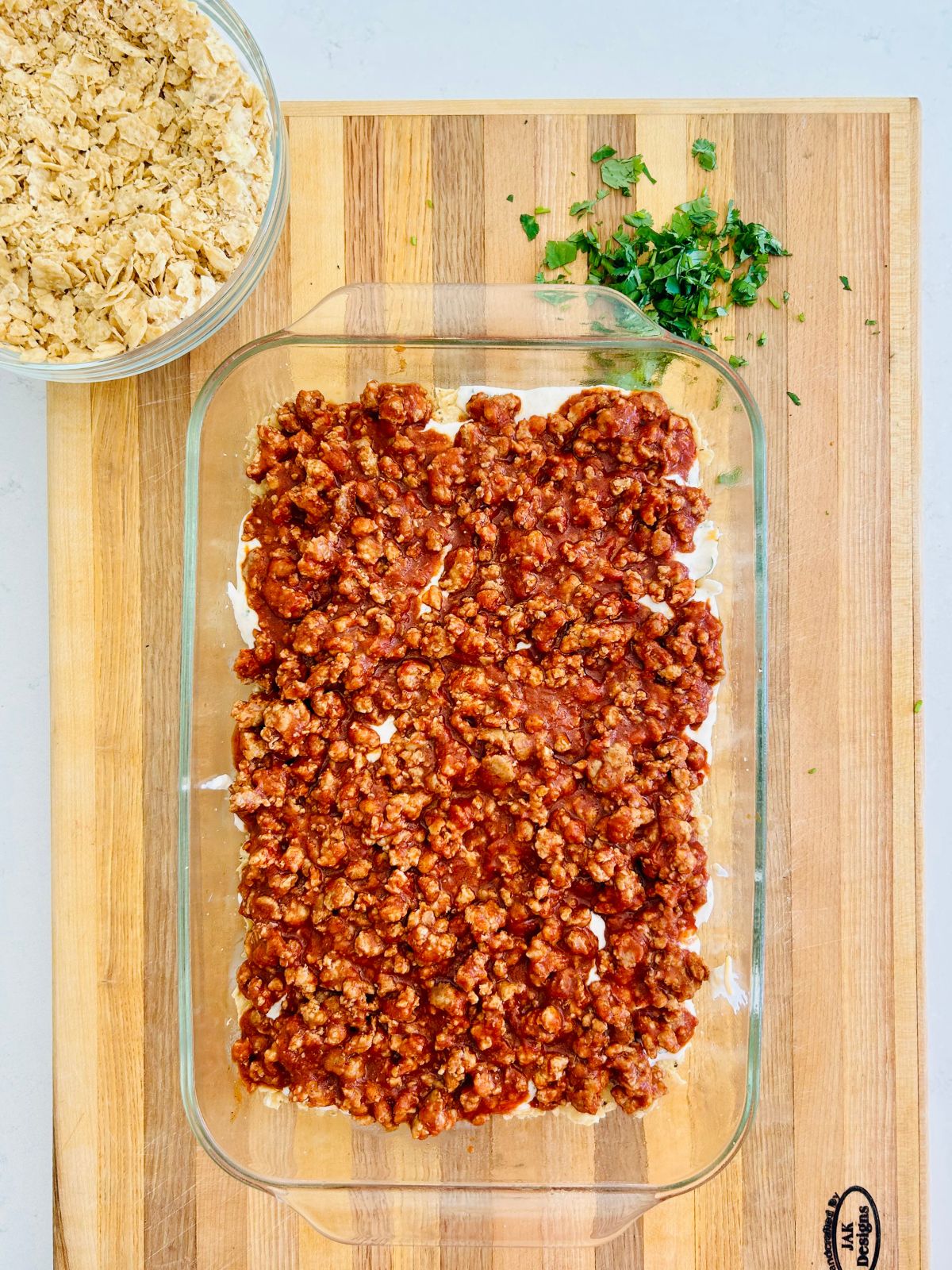 Taco casserole has a healthy layer of seasoned ground beef in the middle.