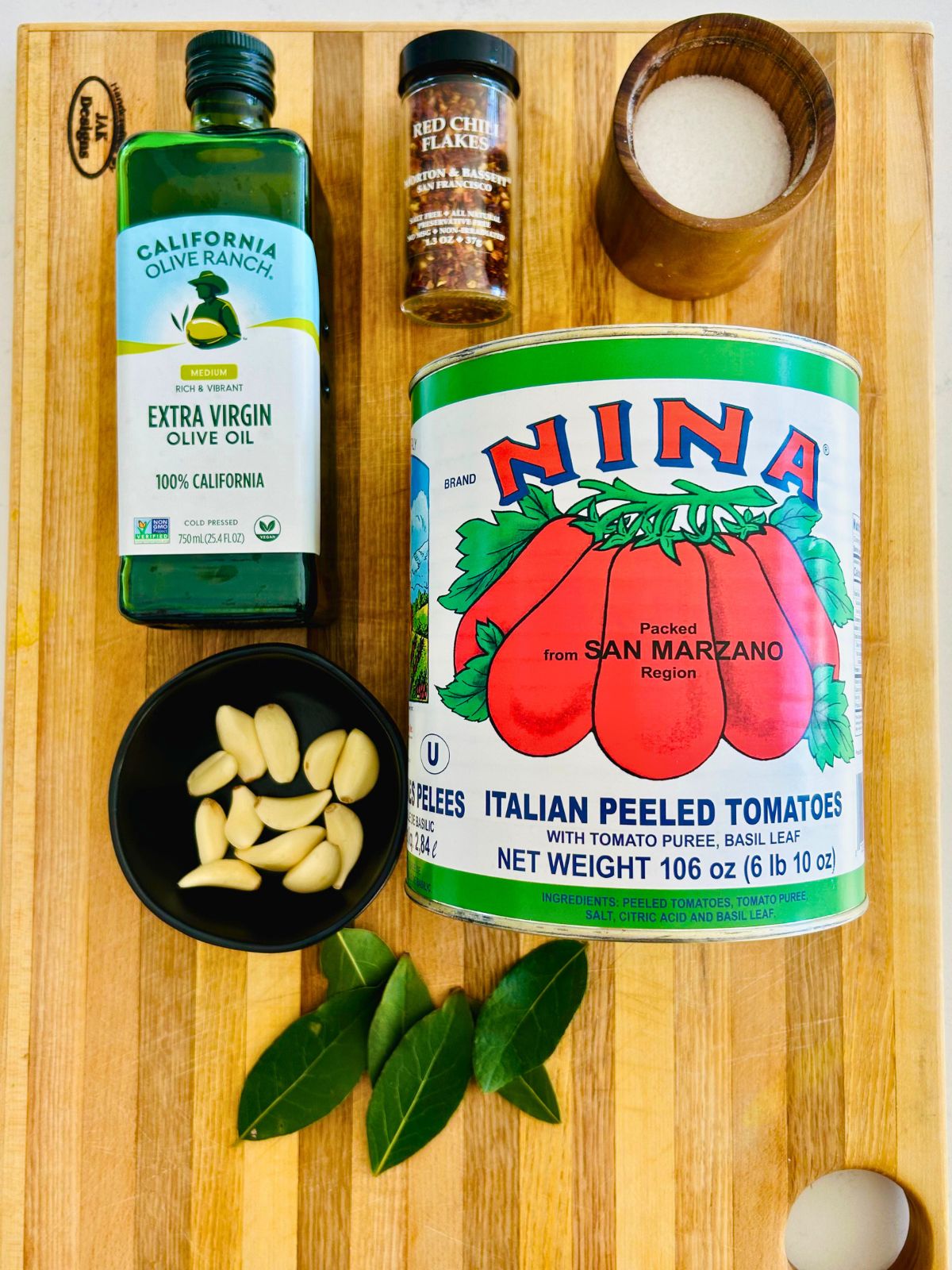 All of the ingredients needed to make San Marzano marinara sauce with canned tomatoes.