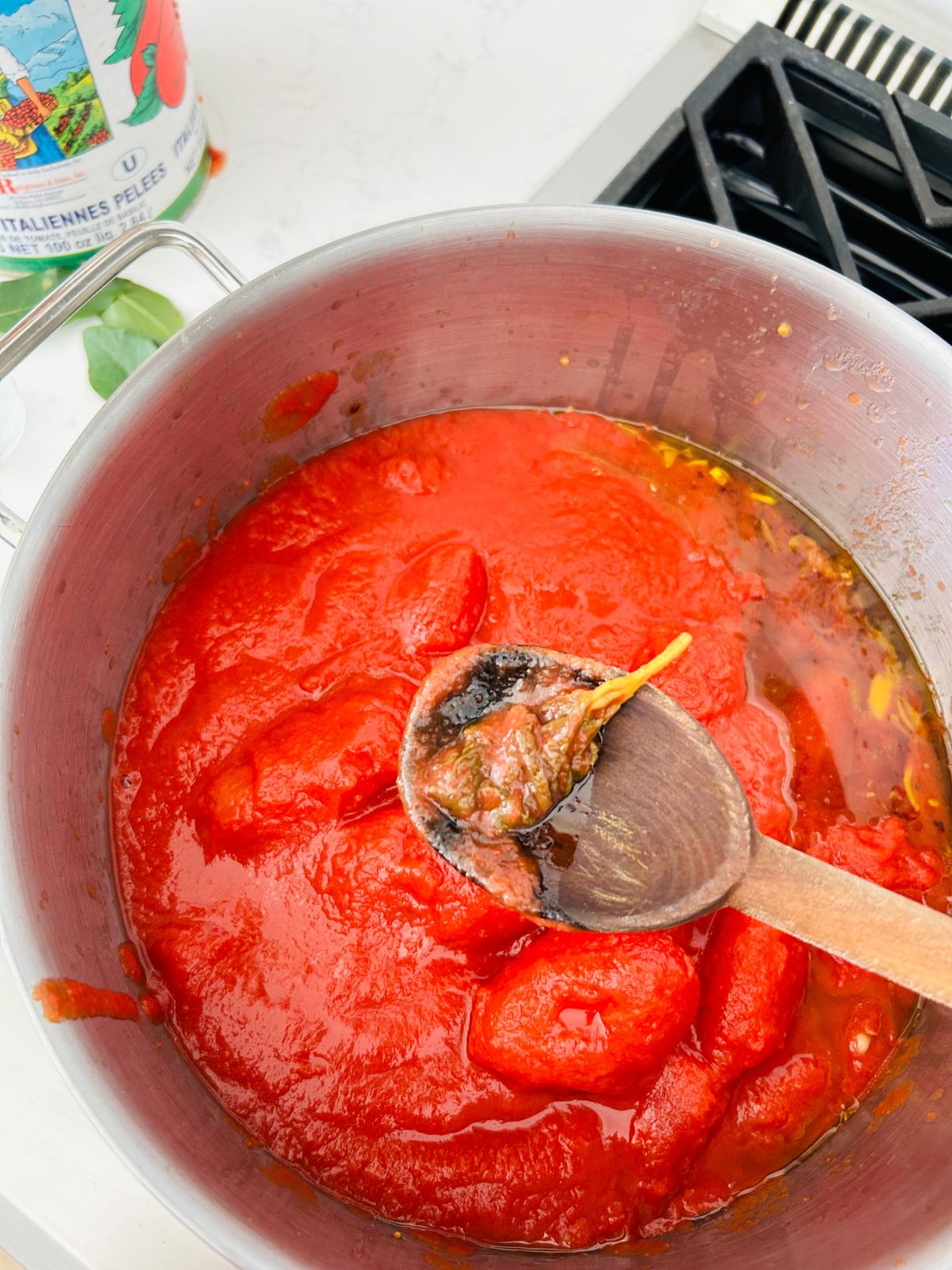 A used basil sprig from the canned tomatoes needs to be thrown away.