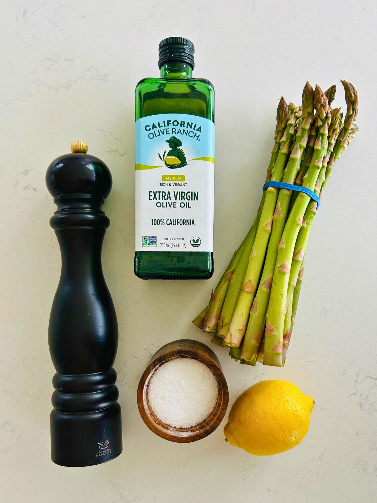 All of the ingredients needed to make sauteed asparagus with lemon.