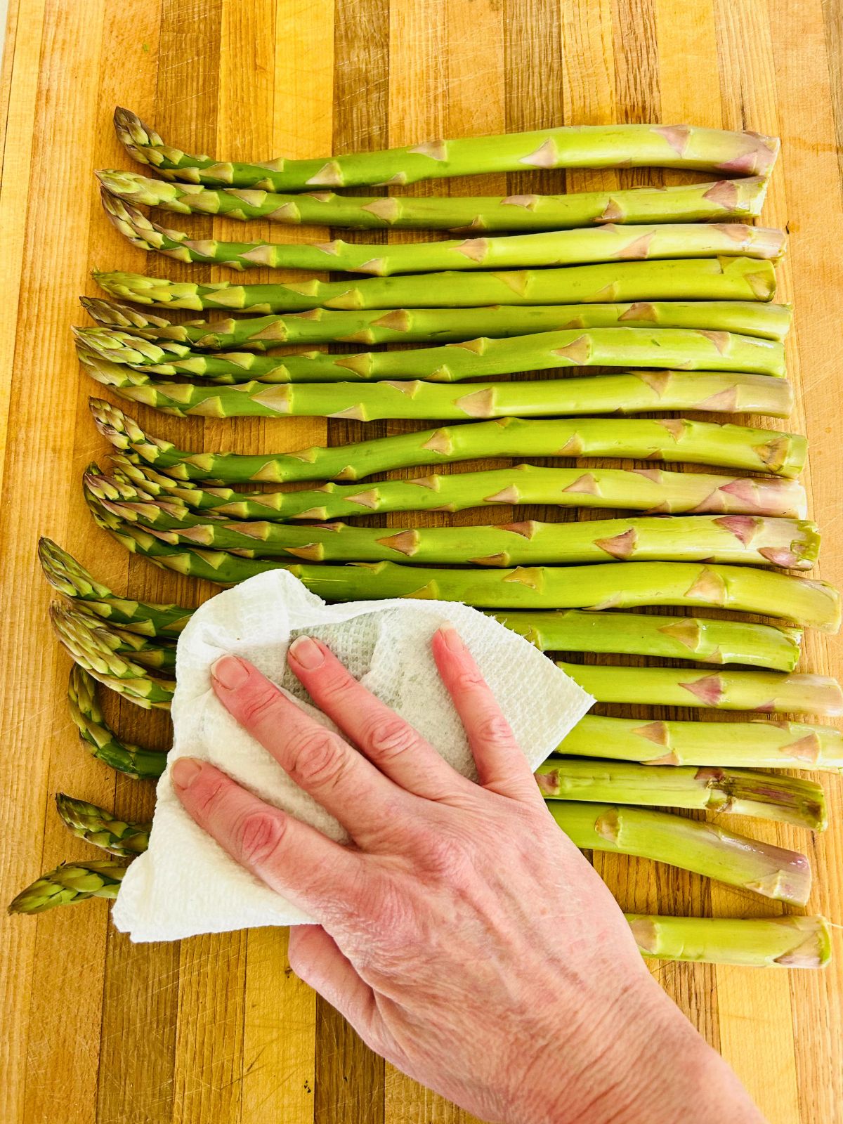 Wash then dry the asparagus with a paper towel before sauteeing them.