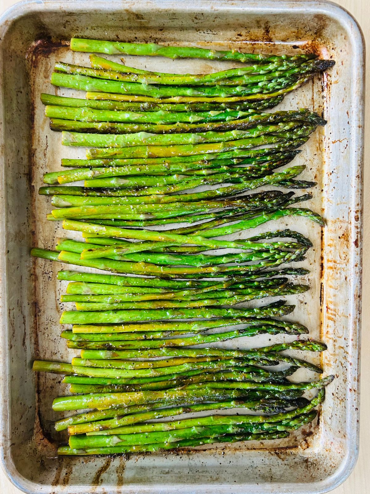 Sauteed asparagus with lemon in a sheet pan waiting to be served.