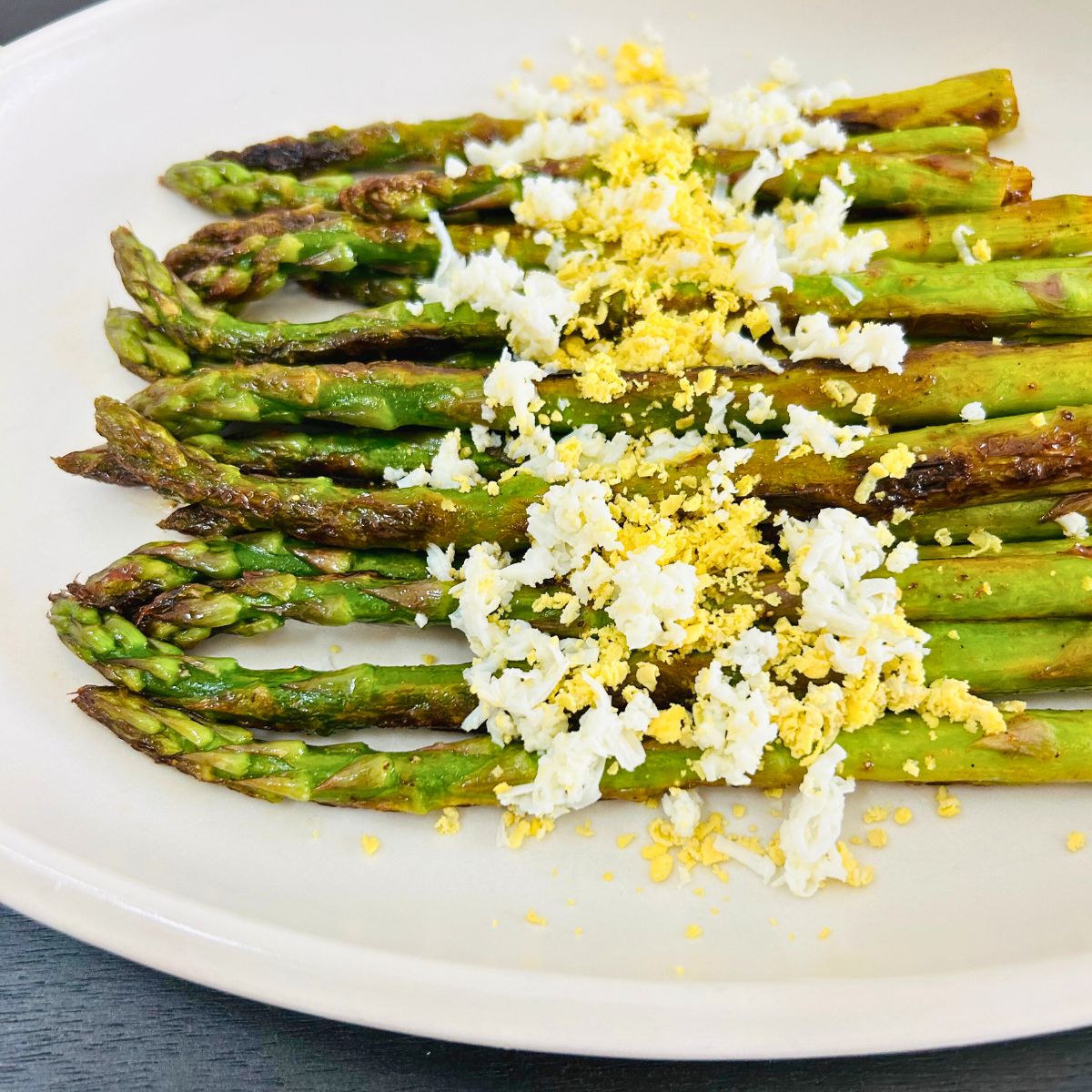 Sauteed asparagus with eggs mimosa sprinkled on top.