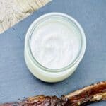 Creamy horseradish sauce in a glass jar.
