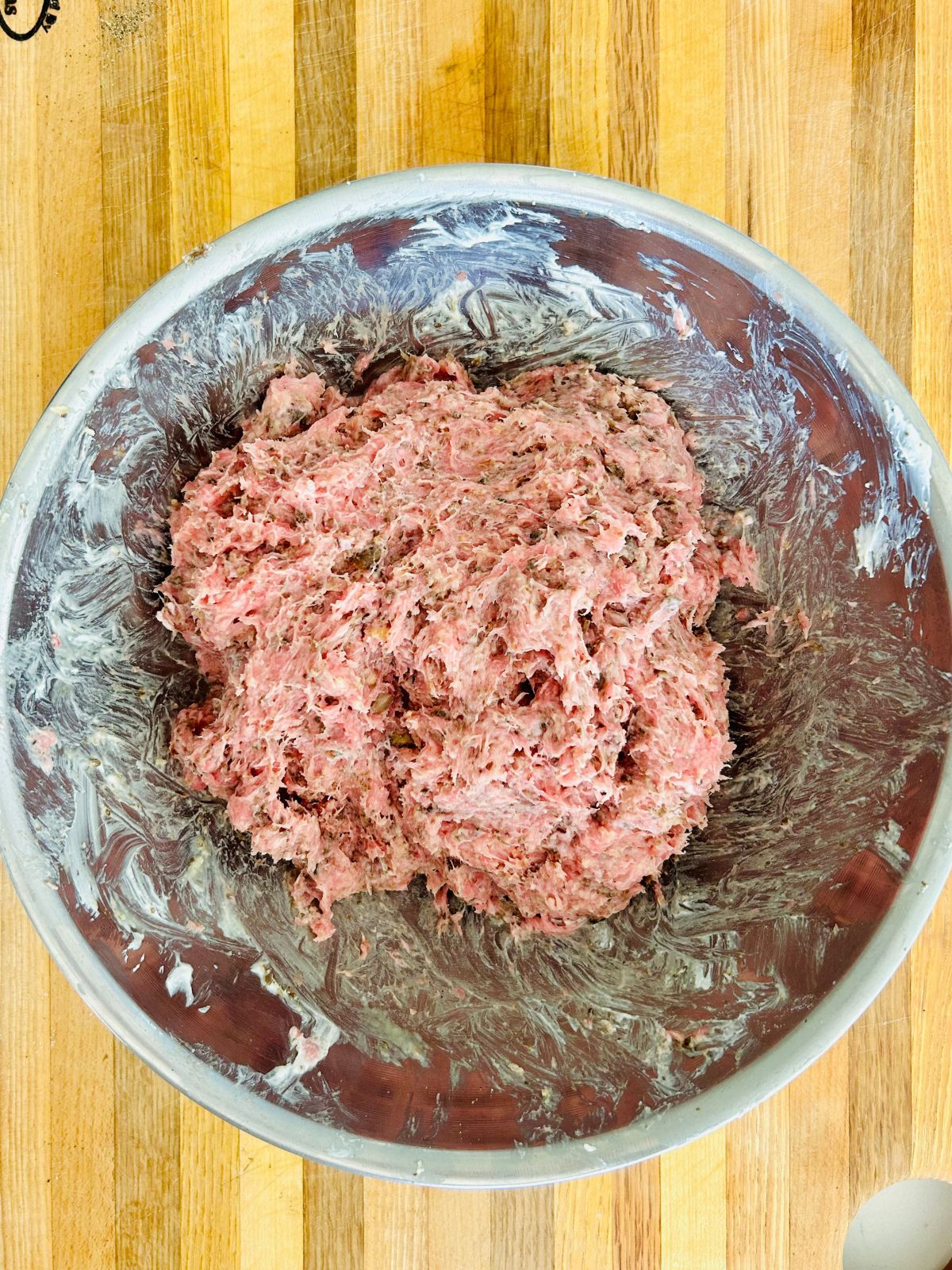 All of the ingredients to juicy turkey burgers combined in a bowl.