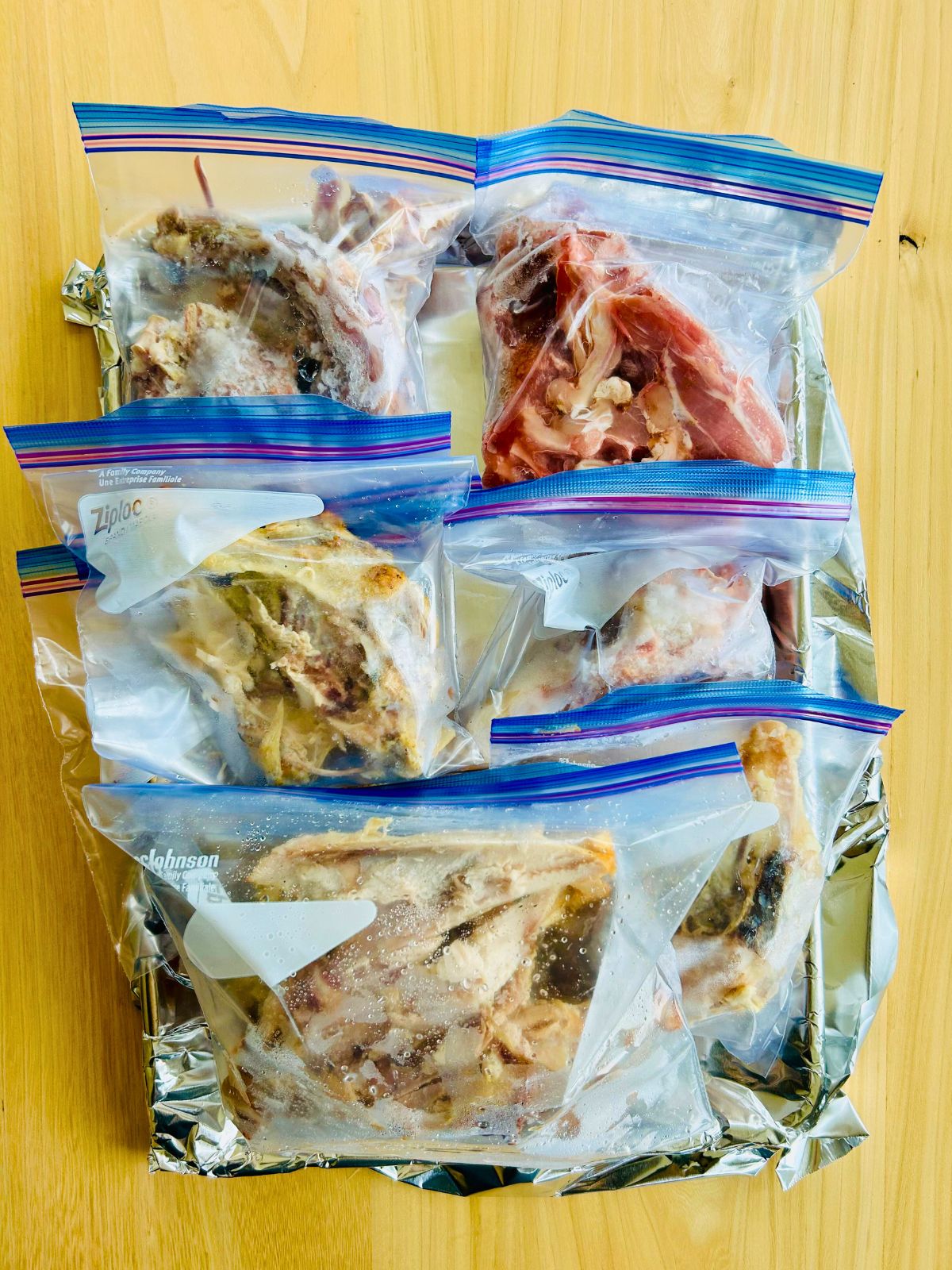 The brown chicken stock key ingredient is a collection of frozen chicken bones in zip lock bags.