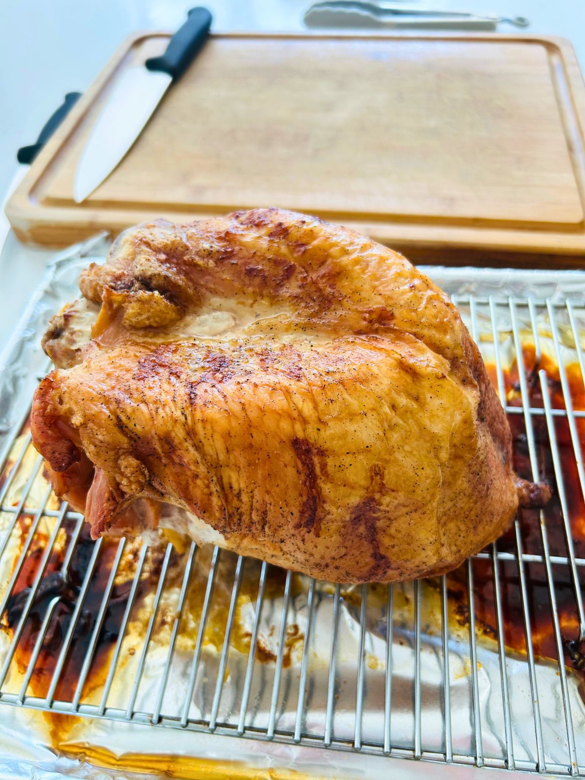 Oven roasted turkey breast with dry brine resting before carving.