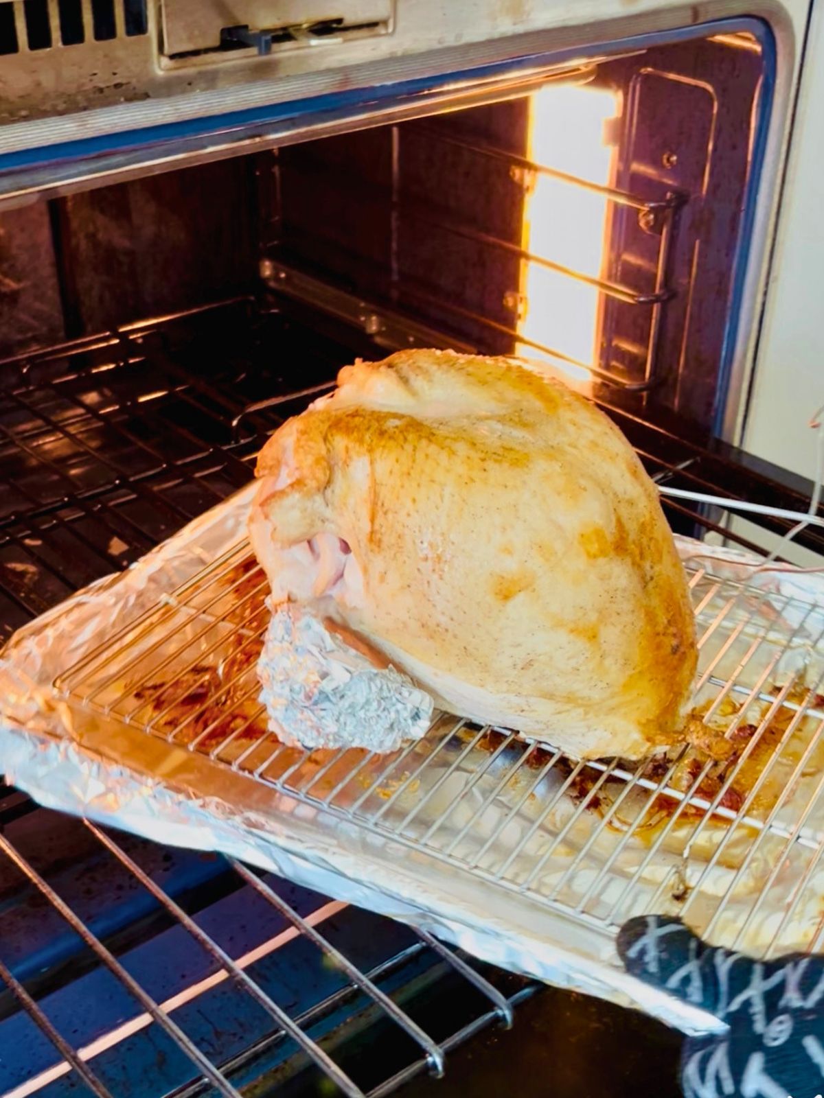 Rotating the turkey breast after an hour of roasting in the oven.