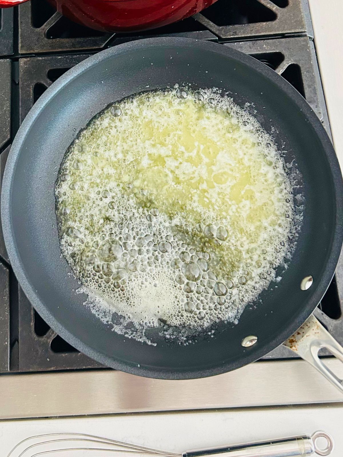 To prepare the roux for the gravy, butter is simmering in the skillet.