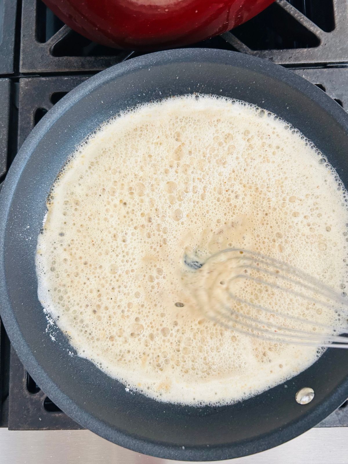 Flour is whisked into butter in a hot skillet.