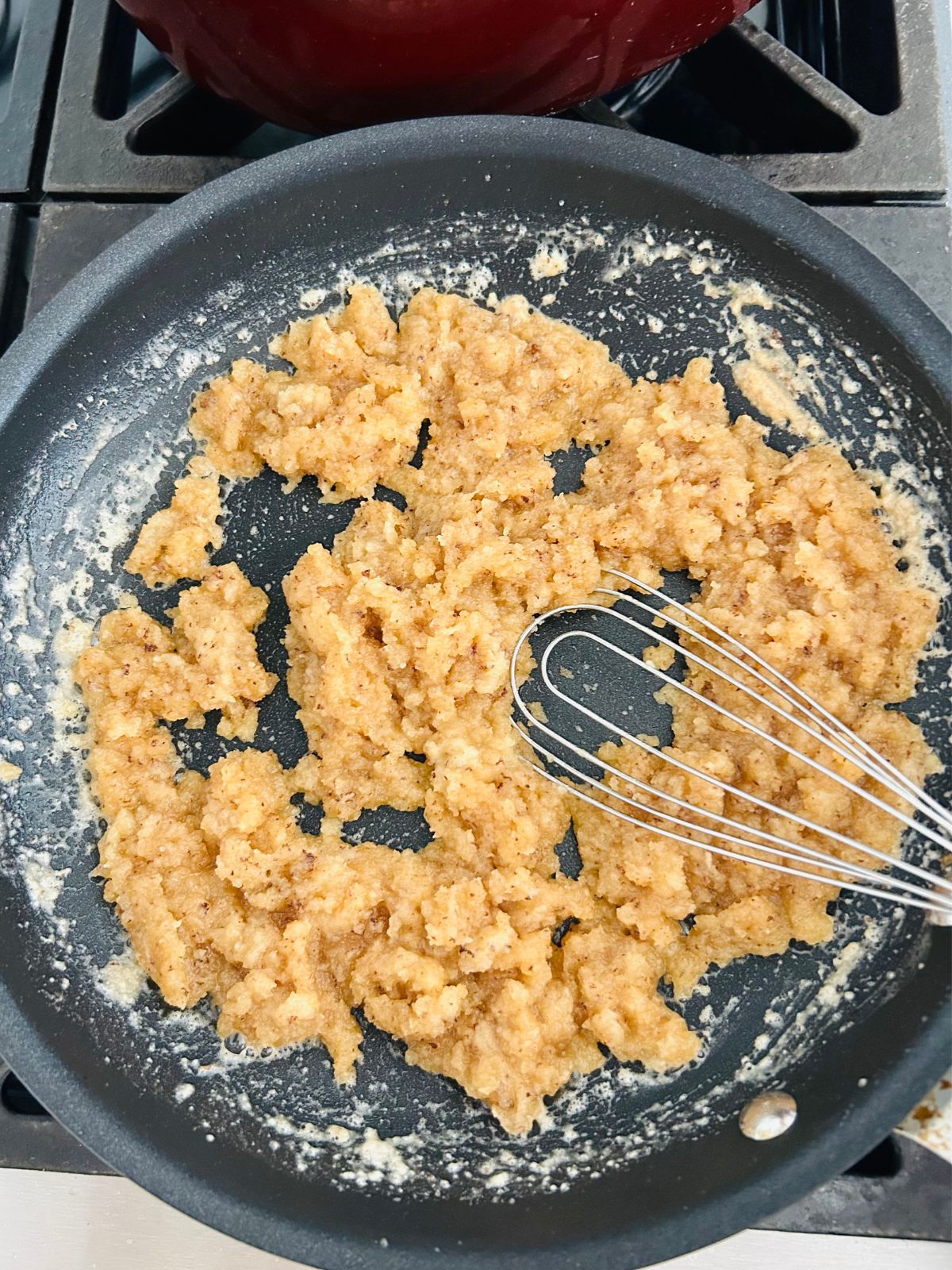 The white wine has been cooked down in a skillet with roux.