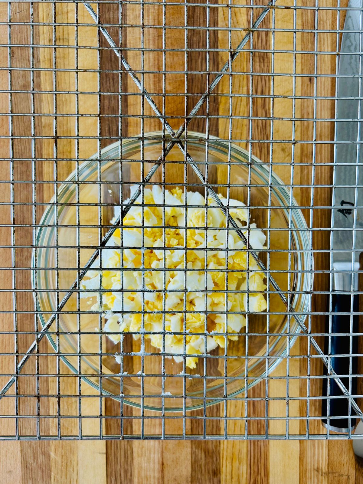 Hard boiled eggs after pushing them thru a metal cooling rack to dice them.