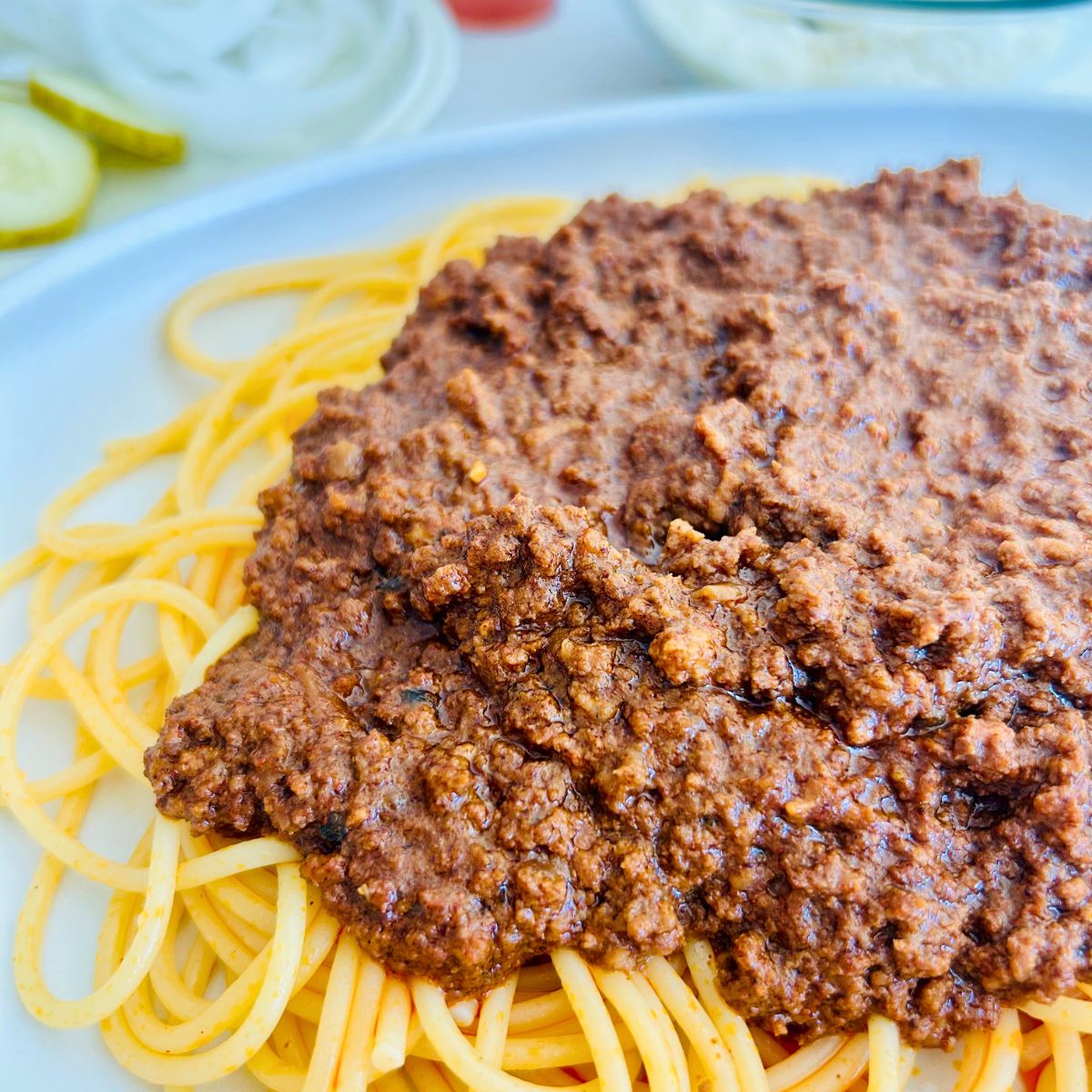 Fred and Red's copycat spaghetti red recipe with chili spooned on top of spaghetti noodles.