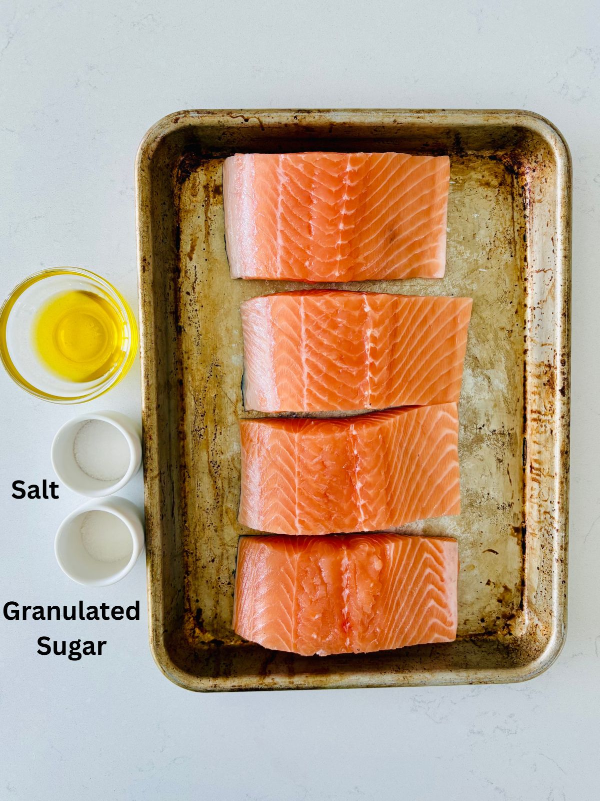 The ingredients needed to make restaurant-style pan-seared salmon with a dry brine.
