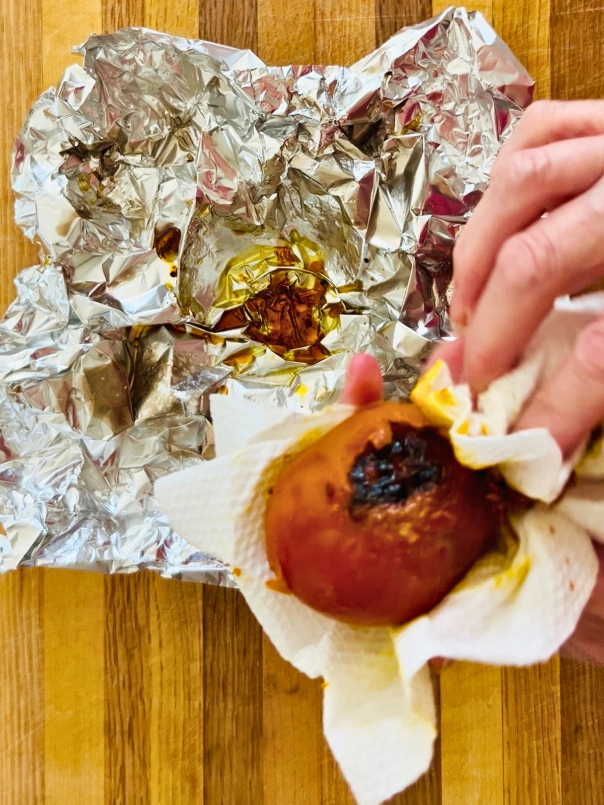 Unwrapping a roasted golden beet from foil before peeling for golden beet soup.