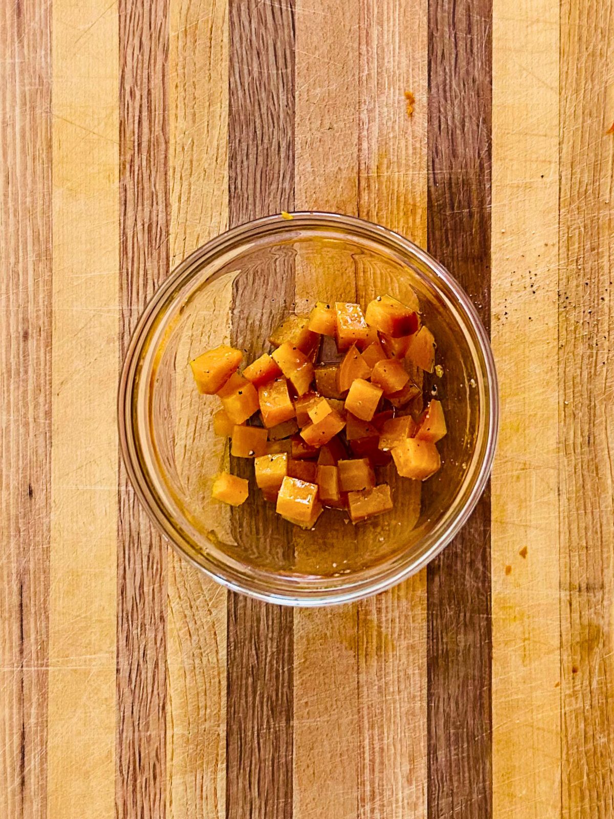 Diced roasted golden beets seasoned in a bowl, ready to garnish golden beet soup.