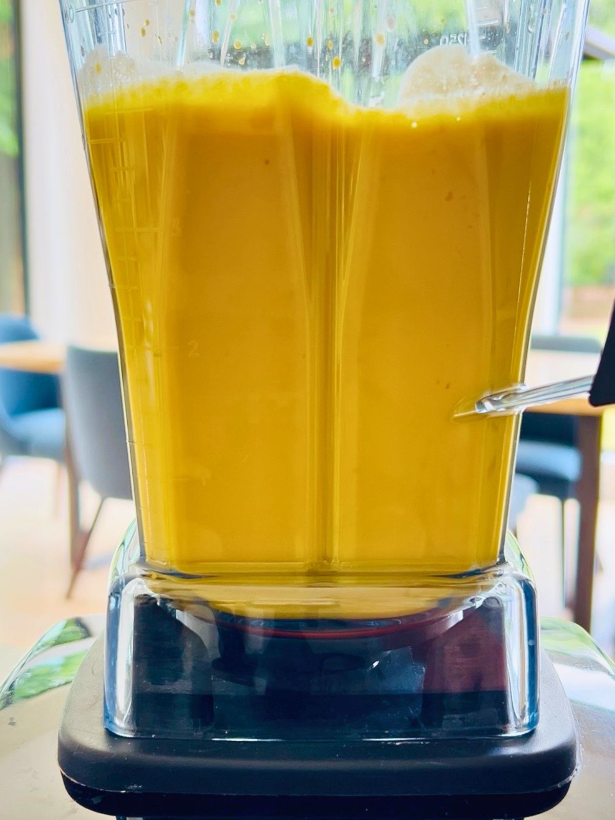 Vibrant golden beet soup with buttermilk blending until smooth and creamy.