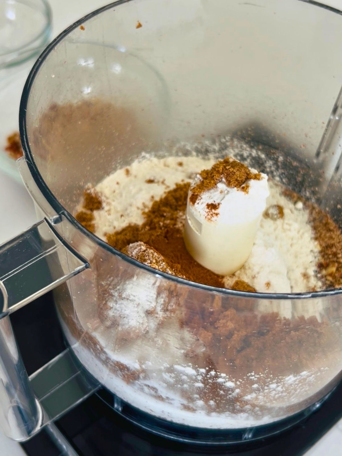 Flour, dark brown sugar, and cinnamon added to the food processor to blend.