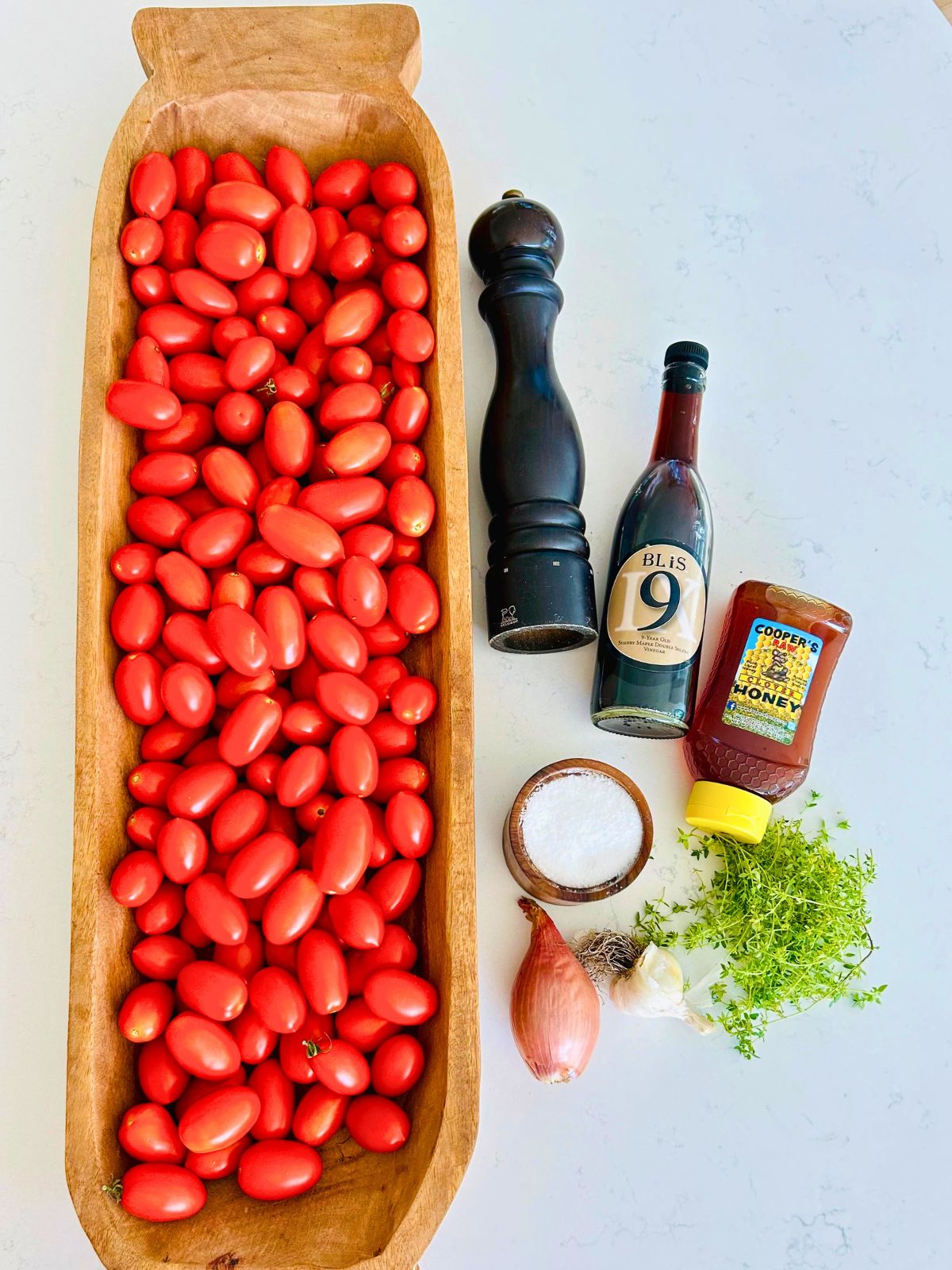 All of the ingredients needed to make homemade tomato paste with fresh tomatoes.