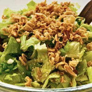 Crunchy romaine salad with toasted ramen noodles, buttery almonds, sesame seeds, and green onions.