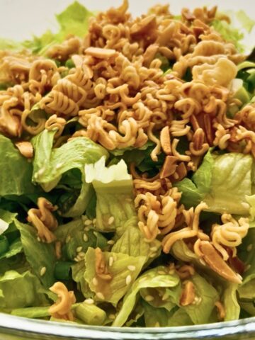 Crunchy romaine salad with toasted ramen noodles, buttery almonds, sesame seeds, and green onions.