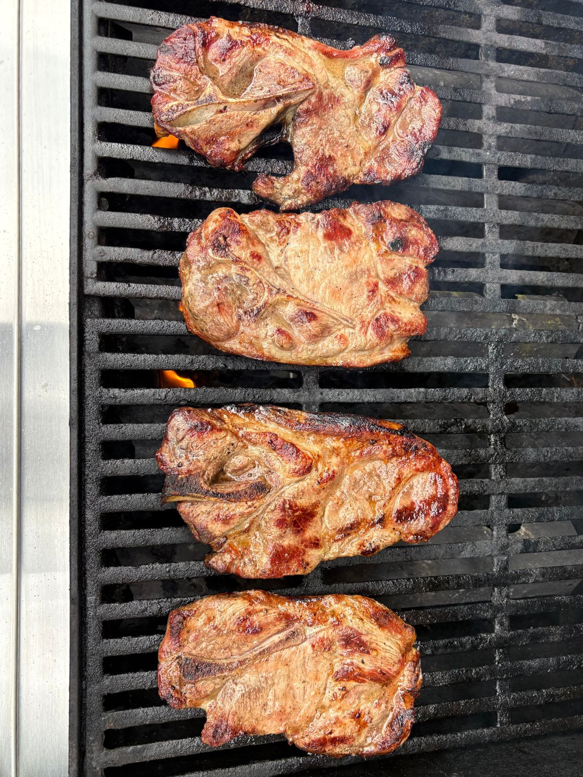 Pork steaks are grilled and basted and ready for BBQ sauce.