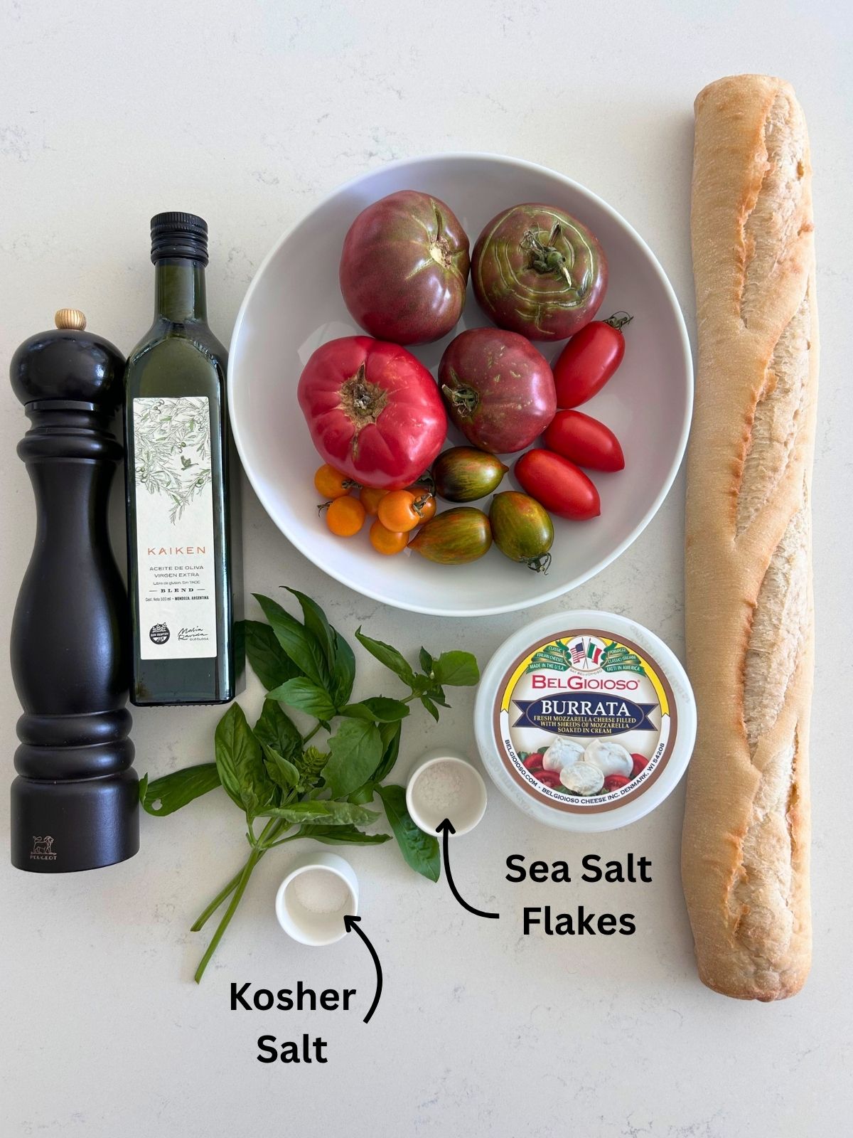 All of the ingredients needed to make burrata and heirloom tomato salad.