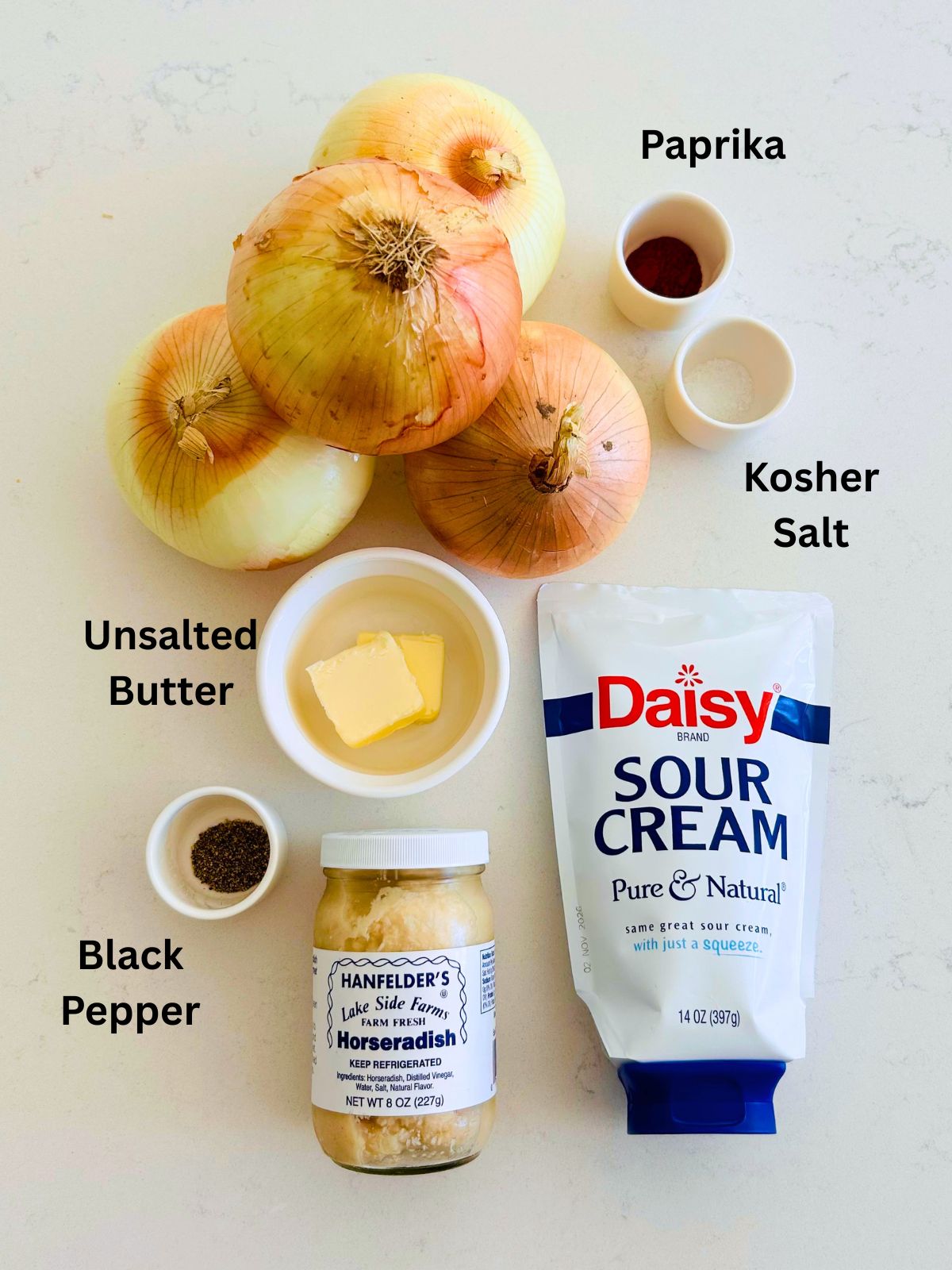 All of the ingredients needed to make caramelized onions and creamy horseradish sauce.