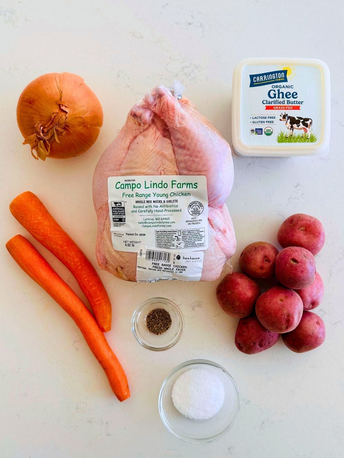 All of the ingredients needed to make juicy skillet roasted chicken with caramelized vegetables.